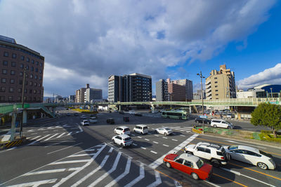 High angle view of cars on road in city against sky