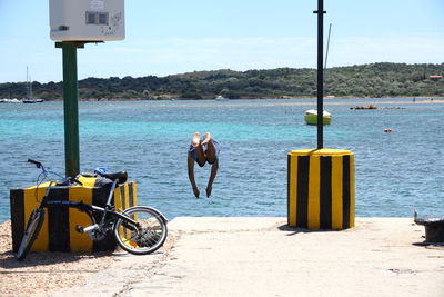 Man on beach by sea against sky