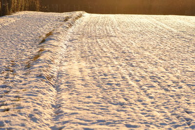 Tire tracks on snow covered field
