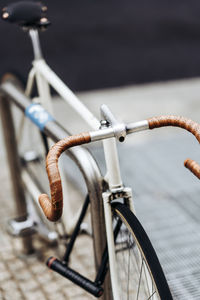 Handlebar of racing bicycle locked to bicycle rack