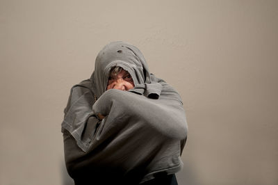 Portrait of man standing against wall