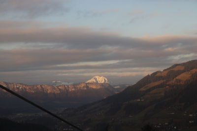 Scenic view of snowcapped mountains against sky during sunset
