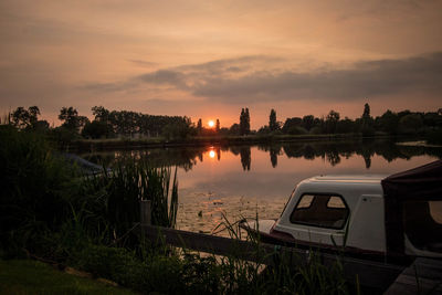 Scenic view of lake against sky at sunset