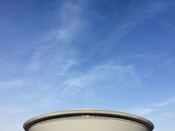 Low angle view of water tower against blue sky