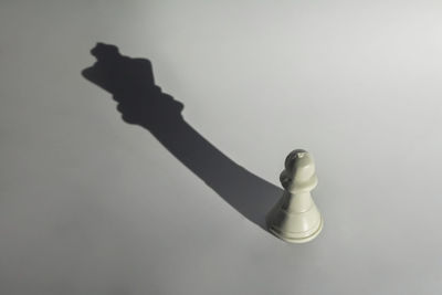 High angle view of chess pieces on white background
