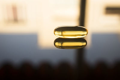 Close-up of pill on table with reflection