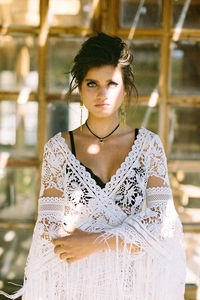 Portrait of young woman standing at home