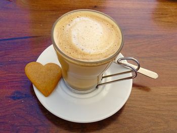 Love coffee with heart shaped biscuit