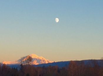 Scenic view of snowcapped mountains against sky at dusk