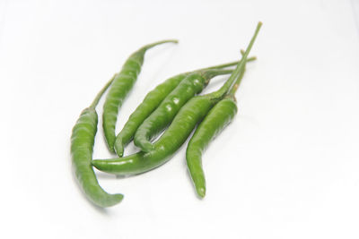 Close-up of green chili pepper against white background