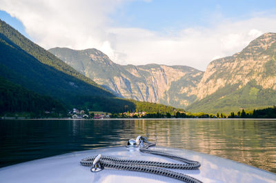 Scenic view of lake by mountains against sky