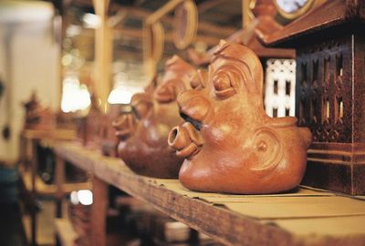 Close-up of statues on shelf in store