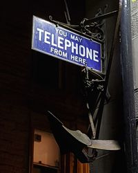 Close-up of information sign hanging on building