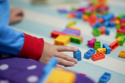 Close-up of hand playing with toy on table