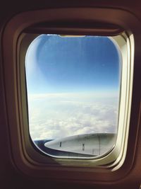 View of cloudy sky seen through airplane window