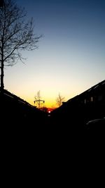 Scenic view of silhouette trees against clear sky during sunset