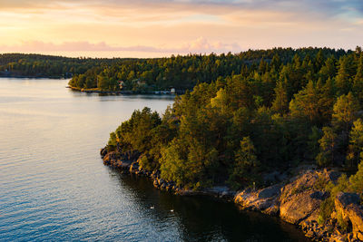 Scenic view of river against sky during sunset