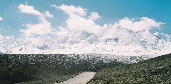 Scenic view of snow covered mountains against sky