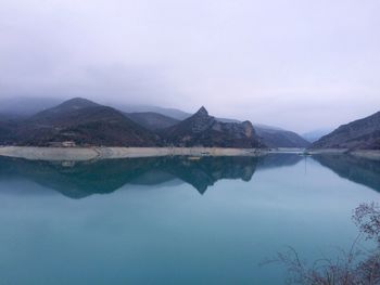 Scenic view of calm lake against mountain range