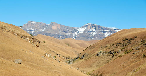 Panoramic view of mountains against clear blue sky