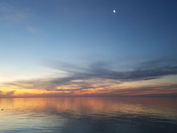 Scenic view of sea against sky at sunset