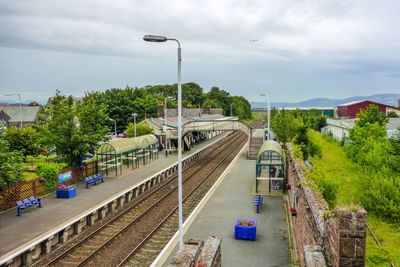 Railroad track against cloudy sky