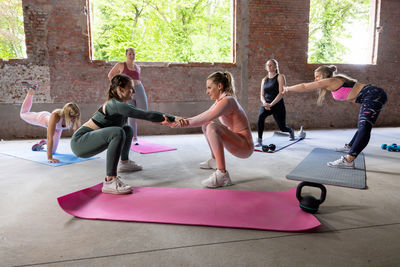 Side view of woman exercising in gym