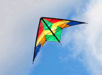 Low angle view of kite flying against sky