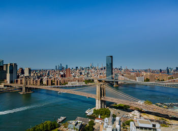 City at waterfront against blue sky