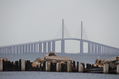 Bridge over sea against sky