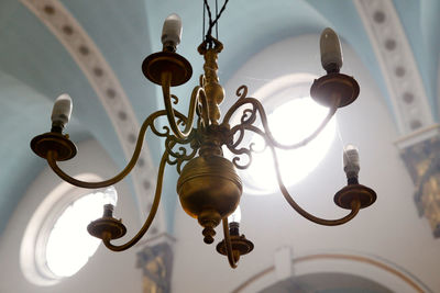 Low angle view of chandelier in brightly lit church