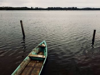 Boat on wooden post in lake