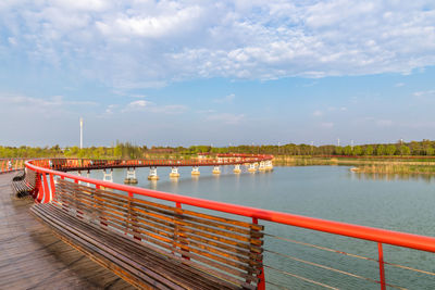 Bridge over lake against sky