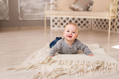 Portrait of cute baby lying on bed