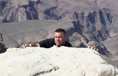 Portrait of man climbing rock at grand canyon national park