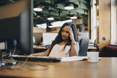 Concentrated businesswoman looking at computer monitor in office