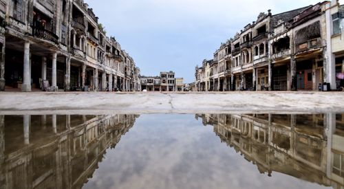 Reflection of buildings in puddle