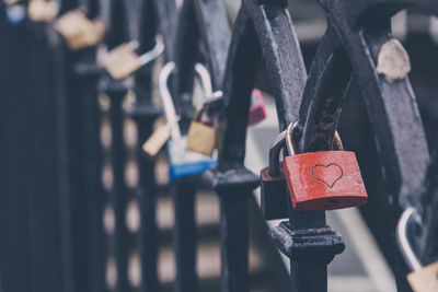 Close-up of padlocks hanging on railing