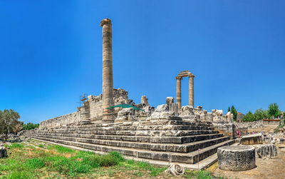 Ruins of temple against clear blue sky