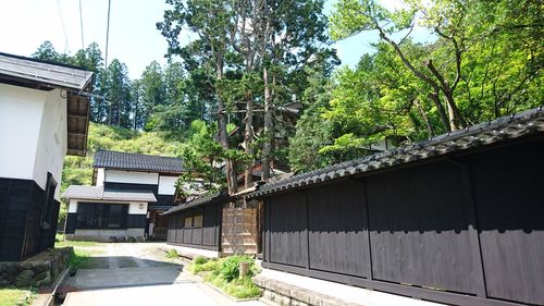 House by trees against sky