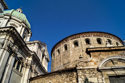 Low angle view of historical building against clear blue sky