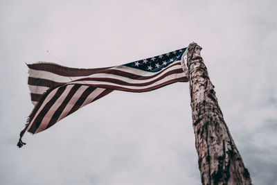 Low angle view of flags against sky