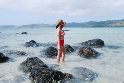 Side view of woman wearing swimwear in sea