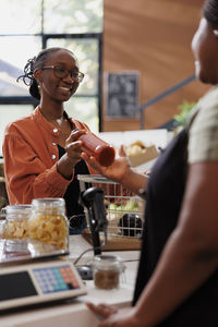 Portrait of young woman preparing food at restaurant