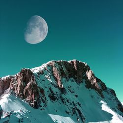 Snowy mountains during full moon