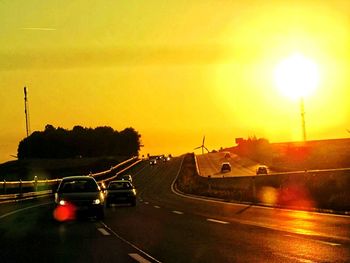 Cars on road at sunset