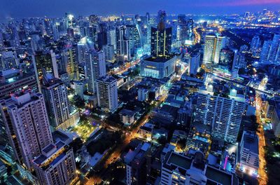 High angle view of city lit up at night