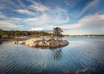 Scenic view of rocks in sea against sky