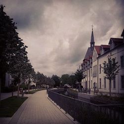 Buildings against cloudy sky