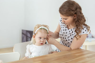 Portrait of cute girl sitting on table